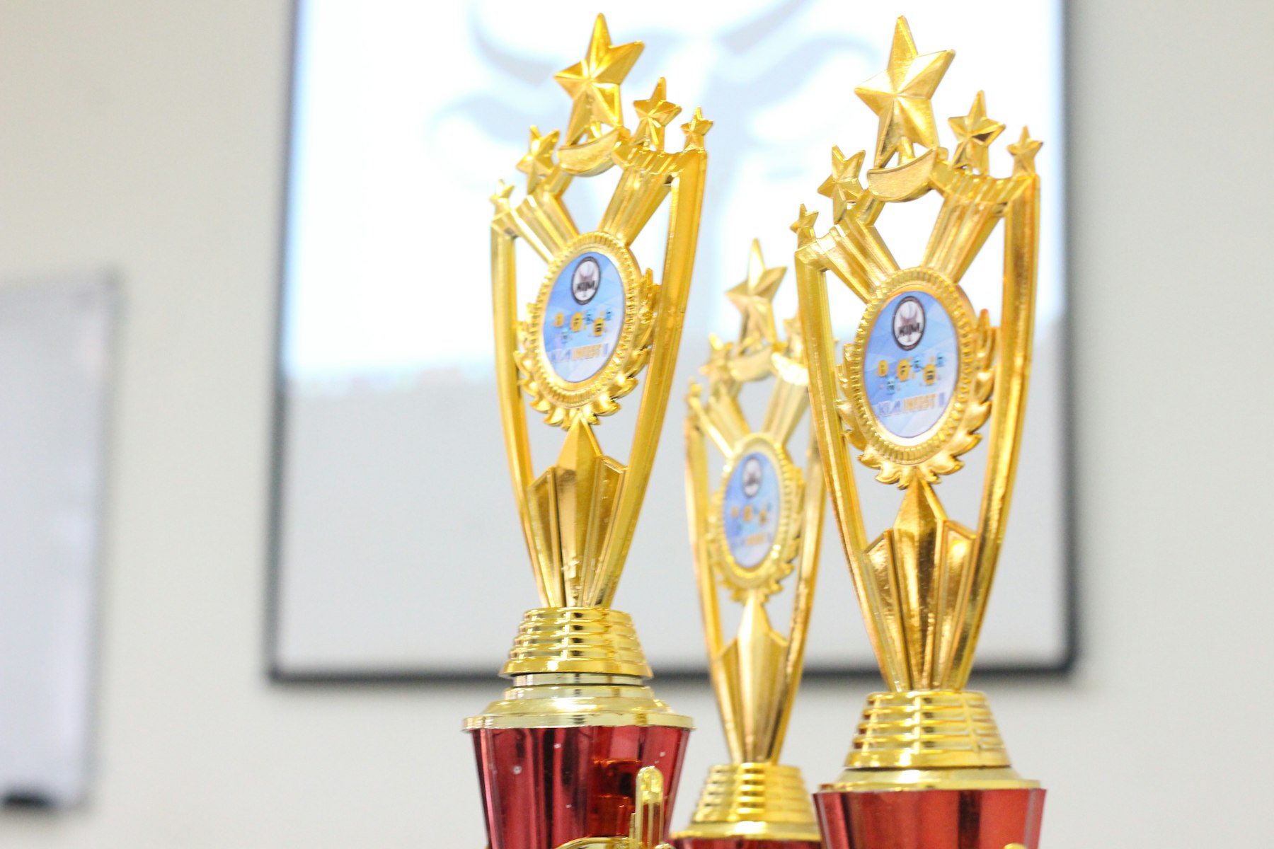 Gold and maroon trophies set out before an awards ceremony
