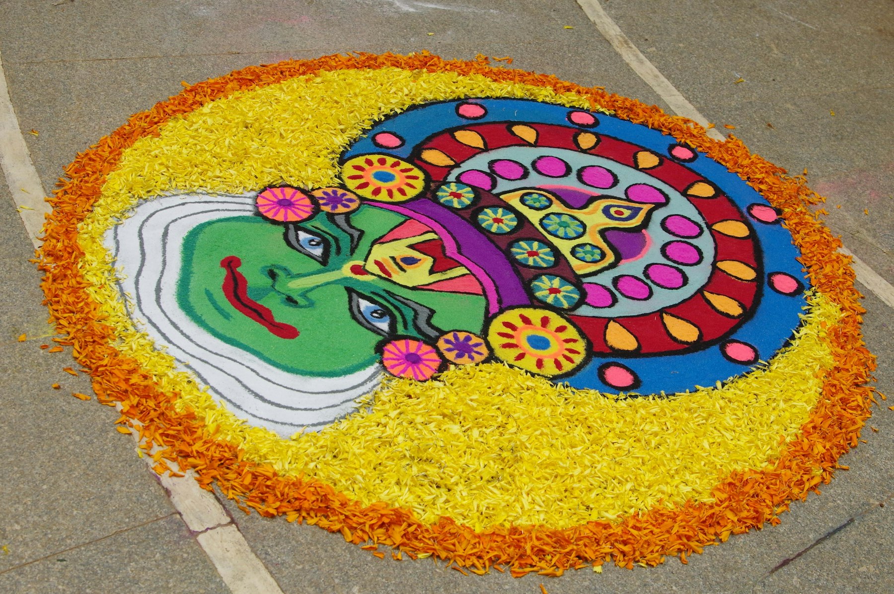A large coloured kolam drawn on the ground for the harvest festival